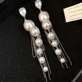 Close-up of long pearl tassel earrings with sparkling zircon studs on black background. - Silver White (26#)