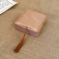Close-up detail of silk fabric jewelry gift box featuring feather pattern and tassel - Bracelet Box (AQ127)