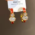 Gold-toned gourd-shaped hoop earrings with red enamel and sparkling cubic zirconia stones. - Gold Red Real Gold Plating (47#)