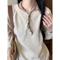 Retro ethnic style fabric necklace with wooden beads shown on model wearing linen top - White (Ethnic Print)
