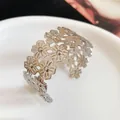 Detailed macro view of silver floral cutout cuff bracelet with polished finish - Hollow Flower Style (HB5173-1) / Silver