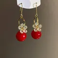 Elegant golden drop earrings featuring a sparkling zircon flower and a vibrant red pearl bead - Gold Red (49#)