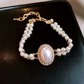 Bracelet perles vintage français doré avec un centre ovale en zircone étincelant - Style Pierre Principale Ovale Perle Double Rang (43#) / Or-Blanc