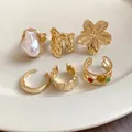 Detailed shot of a 6-piece gold-tone irregular geometric open ring set on a plate - Gold (6-Piece Set)