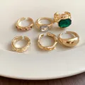 Macro view of golden geometric open ring set with emerald and sparkling rhinestone details - Gold (6-Piece Set)