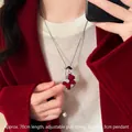 Close-up detail of red flocked sweater necklace with adjustable chain and pearl drop - Silver-Red