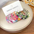 Close-up of five pairs of colorful marbled acetate hoop earrings on a fashion display card. - Silver Tone Earrings (6 Pieces Set) / 6-Piece Set / Colorful