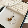 Elegant flocked rocking horse pendant necklace with pearl tassel and adjustable pull chain - Silver-Coffee