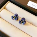 Macro detail of elegant pansy flower stud earrings with enamel petals and crystal centers - Purple Mixed
