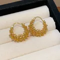 Detailed view of 18k gold plated hoop earrings with unique beaded texture - Hollow Round Hoop / Gold