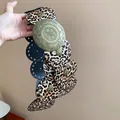 Close-up of vintage leopard print leather belt with ornate bronze metal buckle - 15# Waist Chain