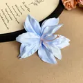Detail view of an elegant light blue artificial lily hair clip with fabric petals. - Lily Flower (HH7384) / Single Piece / Blue