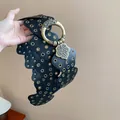 Close-up of black leather wide belt with bronze grommets and ornate round buckle - 16# Waist Chain