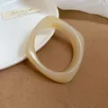 Minimalist cream acrylic resin bangle with irregular geometric shape and glossy finish. - Irregular Geometric (HB3743-1) / White