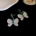 Detailed view of elegant silver butterfly earrings with vibrant green gemstones - Butterfly Earrings (Silver)