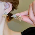 Close-up of elegant gold starfish earrings with sparkling rhinestones on model - Butterfly Starfish Style (2) / Gold - Real Gold Plated