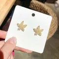 Exquisite gold-plated starfish stud earrings featuring delicate white seed pearl details - Beach Seed Bead Style / Gold