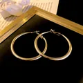 Large gold-tone geometric metal hoop earrings with silver needles for elegant women - Large Earrings