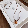 Retro Zen style necklace featuring an amber-like gemstone pendant on a brown cord. - 33# Gold Brown Round Plate Style
