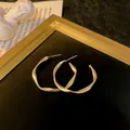 Elegant matte gold twisted geometric hoop earrings with premium 925 silver needles. - Large C-Shape Hoop