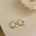 Elegant twisted hoop earrings with white enamel and gold finish, S925 silver needle jewelry - Twist White Enamel Style