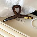 Elegant tortoiseshell hair claw clip featuring a golden brand logo for women's hairstyle - Tortoiseshell Letter Style / 36# Claw Clip - Coffee