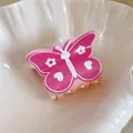 Pink butterfly hair claw clip with cute floral patterns presented inside a white shell dish - Heart Print Butterfly Style / Rose Pink