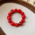 Detailed macro view of red acrylic geometric beads and round beads bracelet - Red