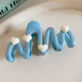 Elegant light blue wavy hair claw clip featuring cute white heart accents for women - Heart Decor Wave Style / Light Blue White