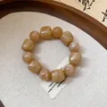 Detailed macro view of acrylic geometric beaded bracelet with warm marble texture - Light Coffee