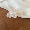 Elegant pearlescent flower hair claw clip with a central pearl in a cream pink finish. - Pearlescent Tiered Flower Style / Light Pink