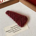 Macro detail of a red plush knitted triangular hair clip on a minimalist wooden tray - Triangle Plush BB Clip