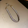 Close-up detail of luxury rhinestone wrapped chain bracelet with sparkling silver finish - Silver