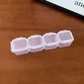 Detailed macro view of a 4-compartment transparent plastic jewelry storage box on wood - 3# Storage Box - 4 Grids / 1 Piece