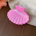 Macro view of a pearlescent pink shell hair claw clip on a elegant silk background. - S / Pink
