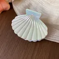 Detailed view of white iridescent shell-shaped hair claw clip with elegant pearl finish - S / Cyan