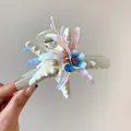 Detailed view of sea star hair claw clip with fabric flowers and blue rhinestone - Multicolor Starfish Flower (HH8279) / Hair Claw