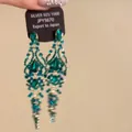 Detailed view of green rhinestone tassel earrings with 925 silver needles on a display card. - Green (Silver Needle)