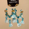 Close-up detail of ethnic style blue crystal bead tassel earrings with flower pendants - 9# Silver Needle-Gold-Blue