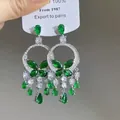 Detailed macro view of vintage ethnic silver earrings featuring green butterfly and tassels. - 10# Silver Earring Post - Silver - Green