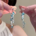 Detailed macro view of elegant silver tassel earrings with sparkling blue crystals - 11# Silver Post - Blue Eight Stones