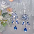 Detailed close-up showing blue floral tassel earrings with butterfly and crystal drops - 12# Ear Hook - Blue