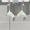 Detailed view of silver mermaid tail earrings featuring pearls and blue star accents. - Mermaid Tail (HE24760) / 16# Silver Post - Silver Stud Type