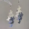 Detail view of multi-colored hollow butterfly charms on elegant tassel earrings - Butterfly Tassel (HE26678) / 18# Ear Hook - White Blue