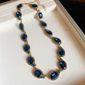 Detailed view of vintage palace style necklace with oval blue stones in gold setting - Necklace (WN689) / Gold/Blue