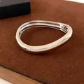 Minimalist irregular curved metal bangle with a polished silver finish for women - Streamlined Closed-Loop Style (29#) / Silver
