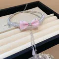 Close-up detail of pink silk bow choker with sparkling zircons and pearl teardrop pendants - Pink Bow Choker / Silver
