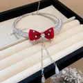 Elegant red satin bow choker necklace with pearls and zircon crystal accents on display - Red Bow Choker / Silver