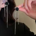 Detailed macro view of an elegant black rose tassel ear cuff with shimmering silver chains - Black Rose Tassel Ear Cuff (22)