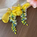 Close-up detail of sweet yellow chiffon bow drop earrings with heart studs and beads. - Heart Flower Tassel Style / Yellow, Blue